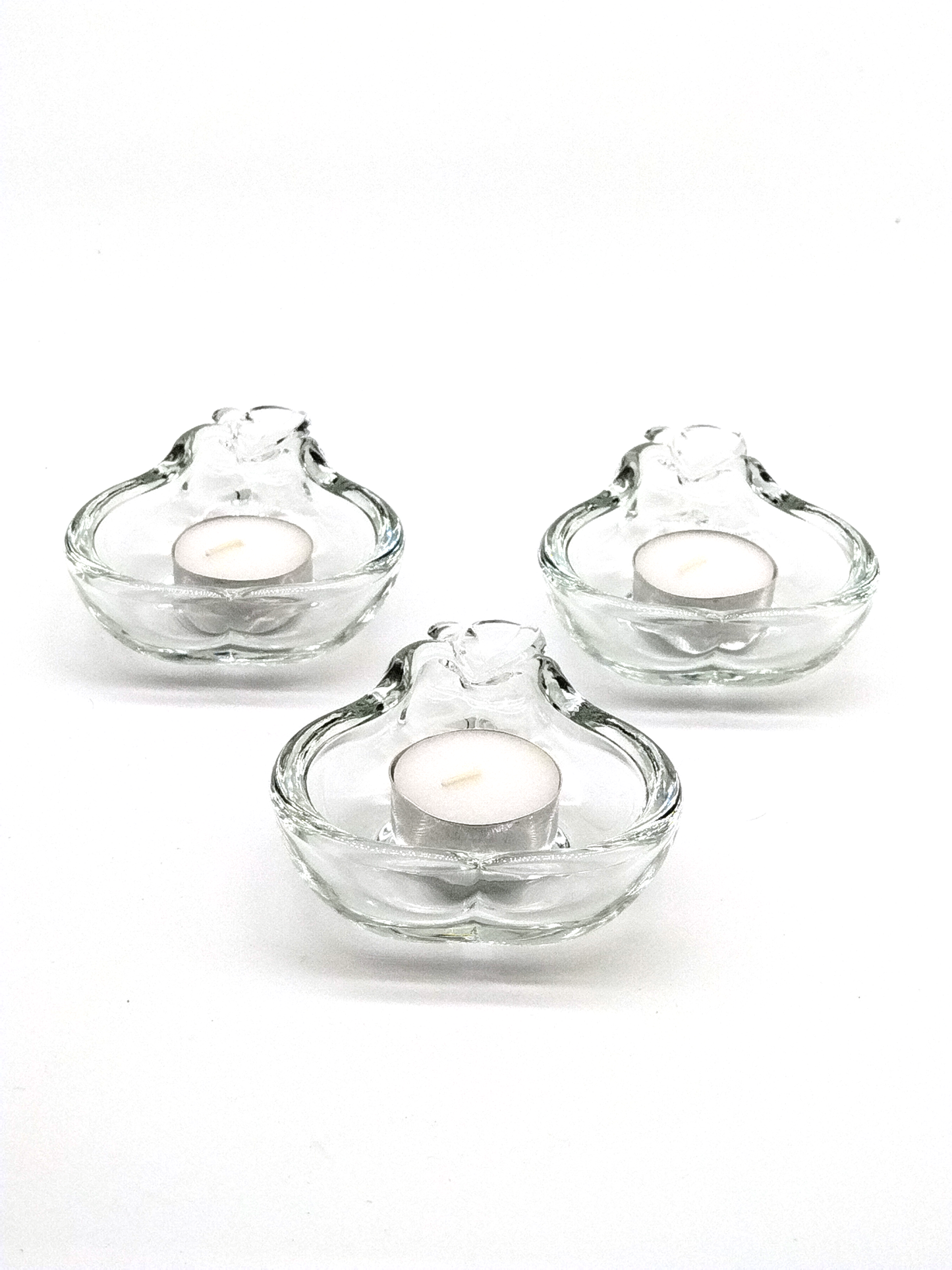 A SET OF THREE CRYSTAL TEA CANDLE HOLDERS IN THE SHAPE OF A PEAR, 12 x 9cm.