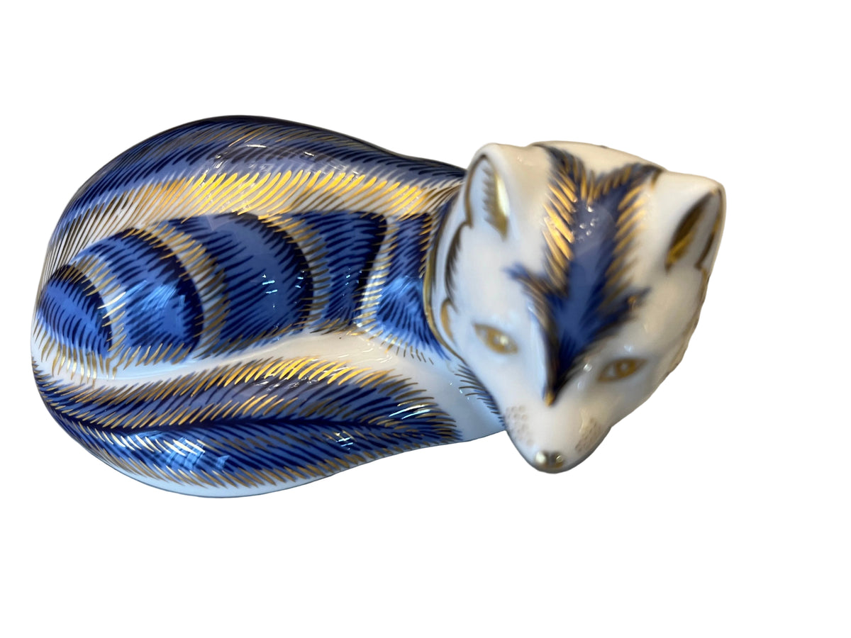 ROYAL CROWN DERBY, PORCELAIN ‘ARTIC FOX’ PAPERWEIGHT, HAND PAINTED BLUE & DECORATION DECORATION, 10 x 5 x 6cm, CIRCA 2004, MADE IN ENGLAND.