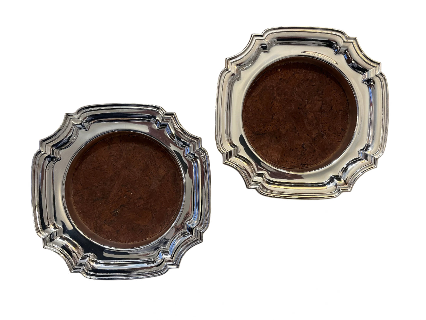 VINERS, PAIR OF SILVER PLATED BOTTLE HOLDERS, SQUARE WITH SHAPED CORNERS, 18cm SQUARE, HEIGHT 3cm.