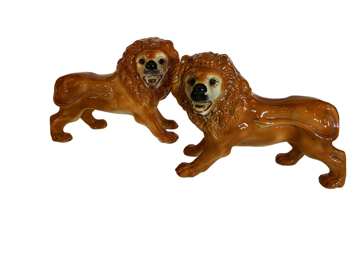 A RARE LARGE PAIR OF STAFFORDSHIRE POTTERY LIONS WITH GLASS EYES, EARLY 20th CENTURY, HEIGHT 27cm, LENGTH 35cm.