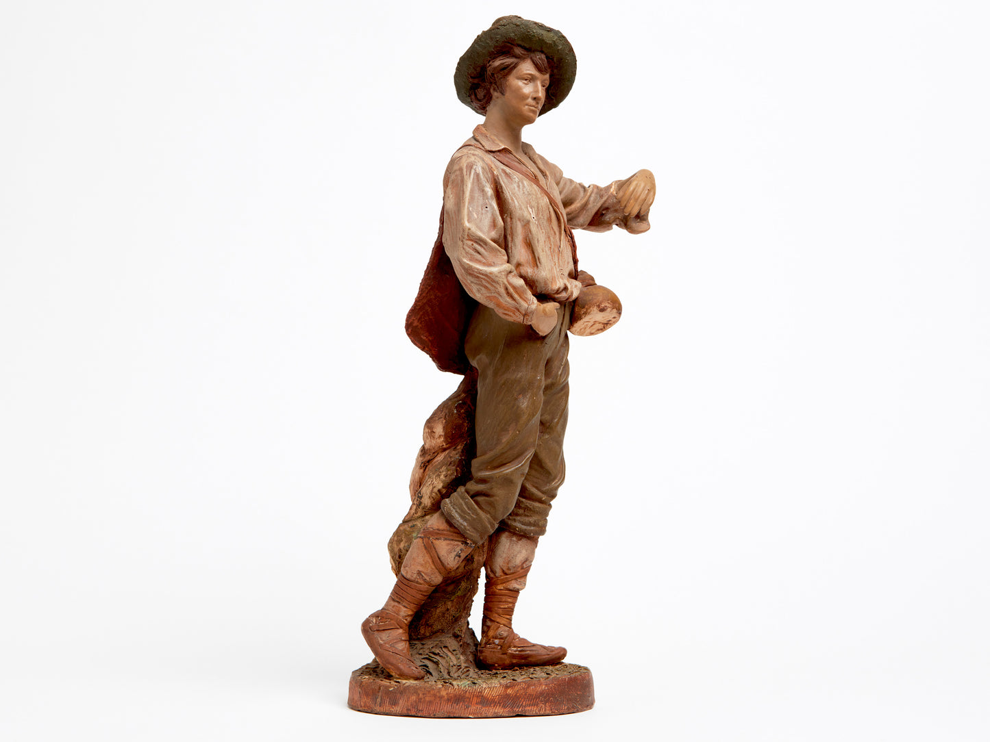 A TERRA COTTA FIGURE OF A FARMER