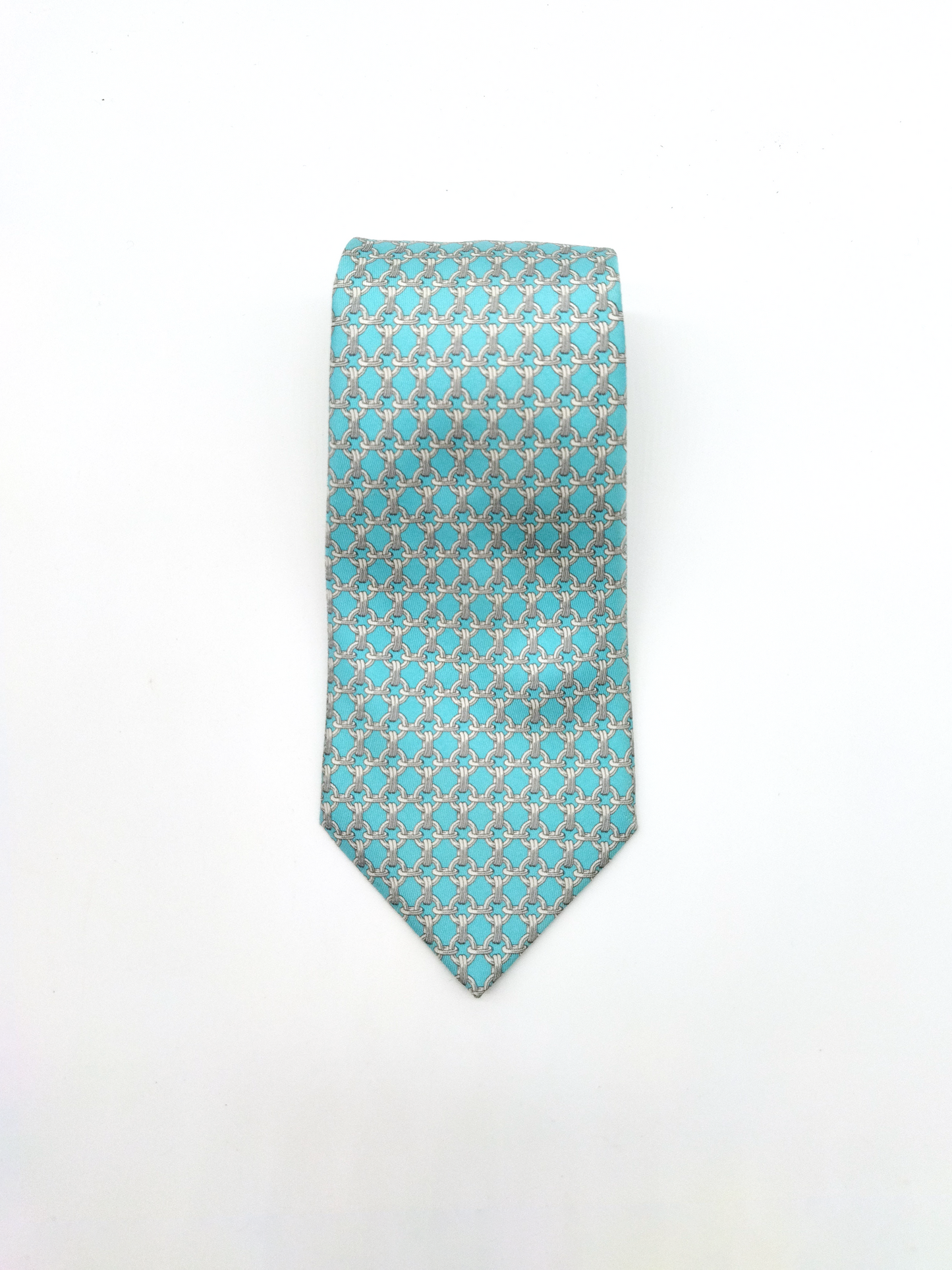 HERMÈS SILK TIE, TURQUOISE BLUE WITH LINK PATTERN.