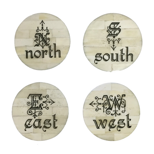 A SET OF FOUR 'DIRECTIONAL' SCRIMSHAW BONE COASTERS, DIAMETER 10cm