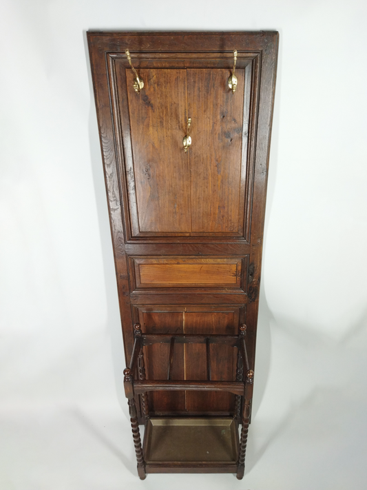 AN OAK HALL AND UMBRELLA STAND CONVERTED FROM AN OLD DOOR, WITH BRASS COAT HOOKS, 177 x 60 x 30cm.