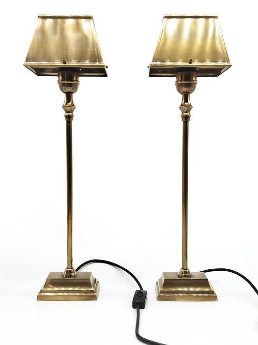 A PAIR OF AGED BRASS STICK TABLE LAMPS WITH CONFORMING RECTANGULAR SHADES, TOTAL HEIGHT 60cm.