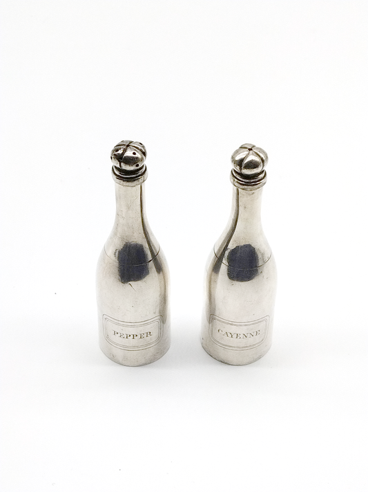 A PAIR OF CHAMPAGNE BOTTLE SILVER PLATED SALT & PEPPER SHAKERS, HEIGHT 13cm.