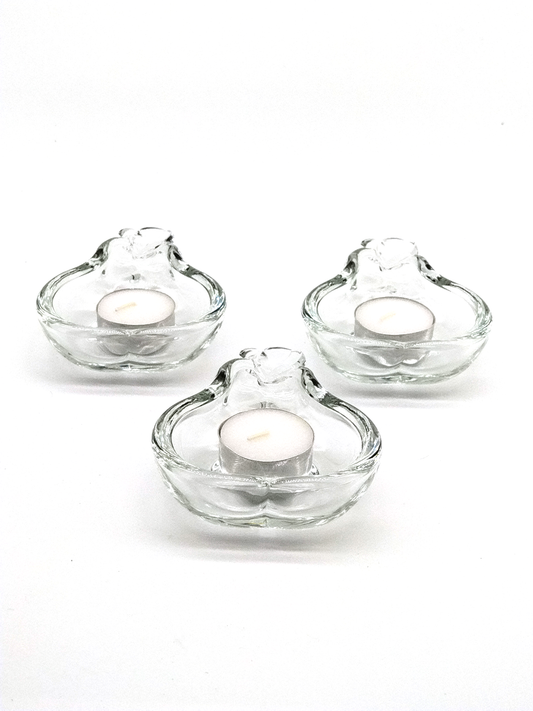 A SET OF THREE CRYSTAL TEA CANDLE HOLDERS IN THE SHAPE OF A PEAR,  12 x 9cm.