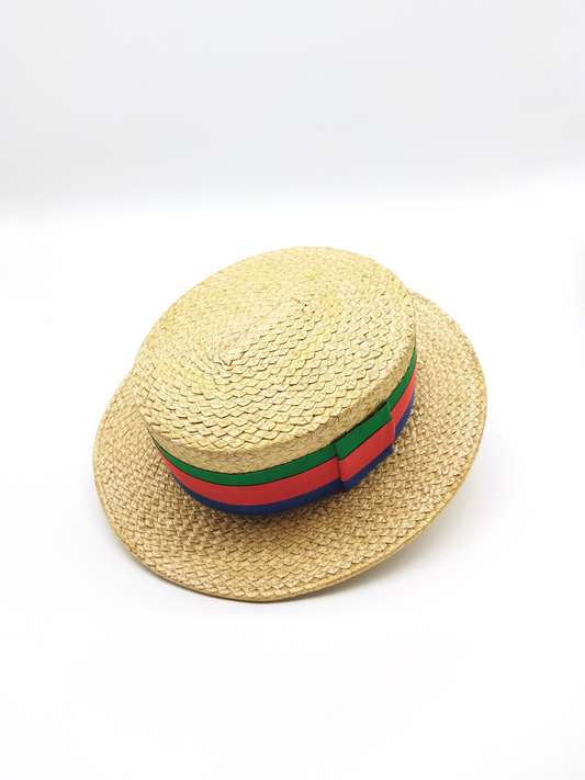 A VINTAGE STRAW BOATER HAT WITH BLUE, RED AND GREEN GROSGRAIN DETAIL, SIZE 59 - 7 1/4.