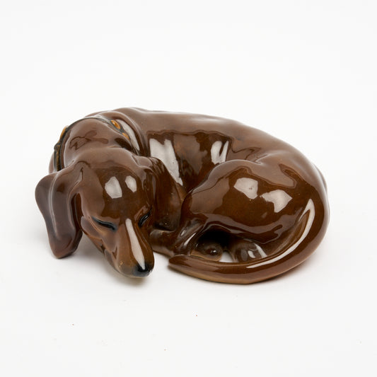 WIENER KUNSTKERMAMISCH WERKSTRATTE, CERAMIC 'SLEEPING DACHSHUND' FIGURE (Wiener Werkstätte 1903-1932), 22 x 17 x 10cm.