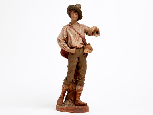 A TERRA COTTA FIGURE OF A FARMER