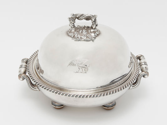 AN ANTIQUE MUFFIN DISH WITH ENGRAVED GRYPHON DECORATION