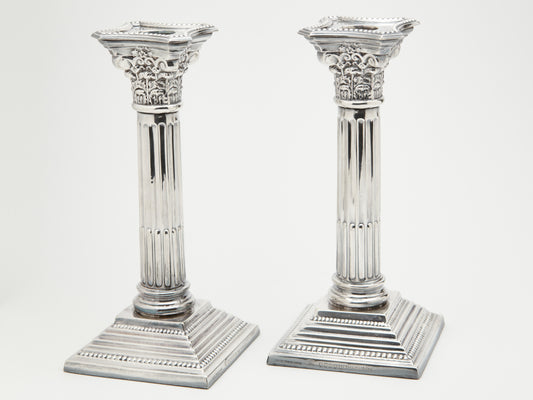 A PAIR OF CLASSIC CORINTHIAN SILVER PLATED CANDLE STICKS