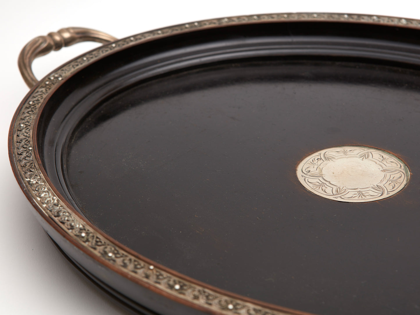 AN ANTIQUE EBONISED AND SILVER TRAY