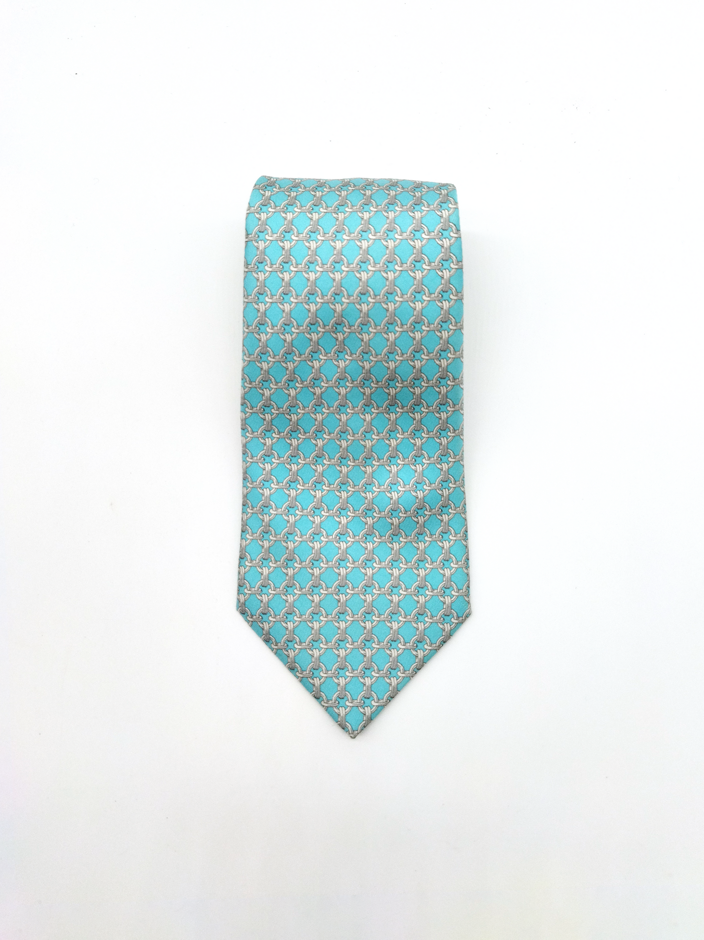 HERMÈS  SILK TIE, TURQUOISE BLUE WITH LINK PATTERN.