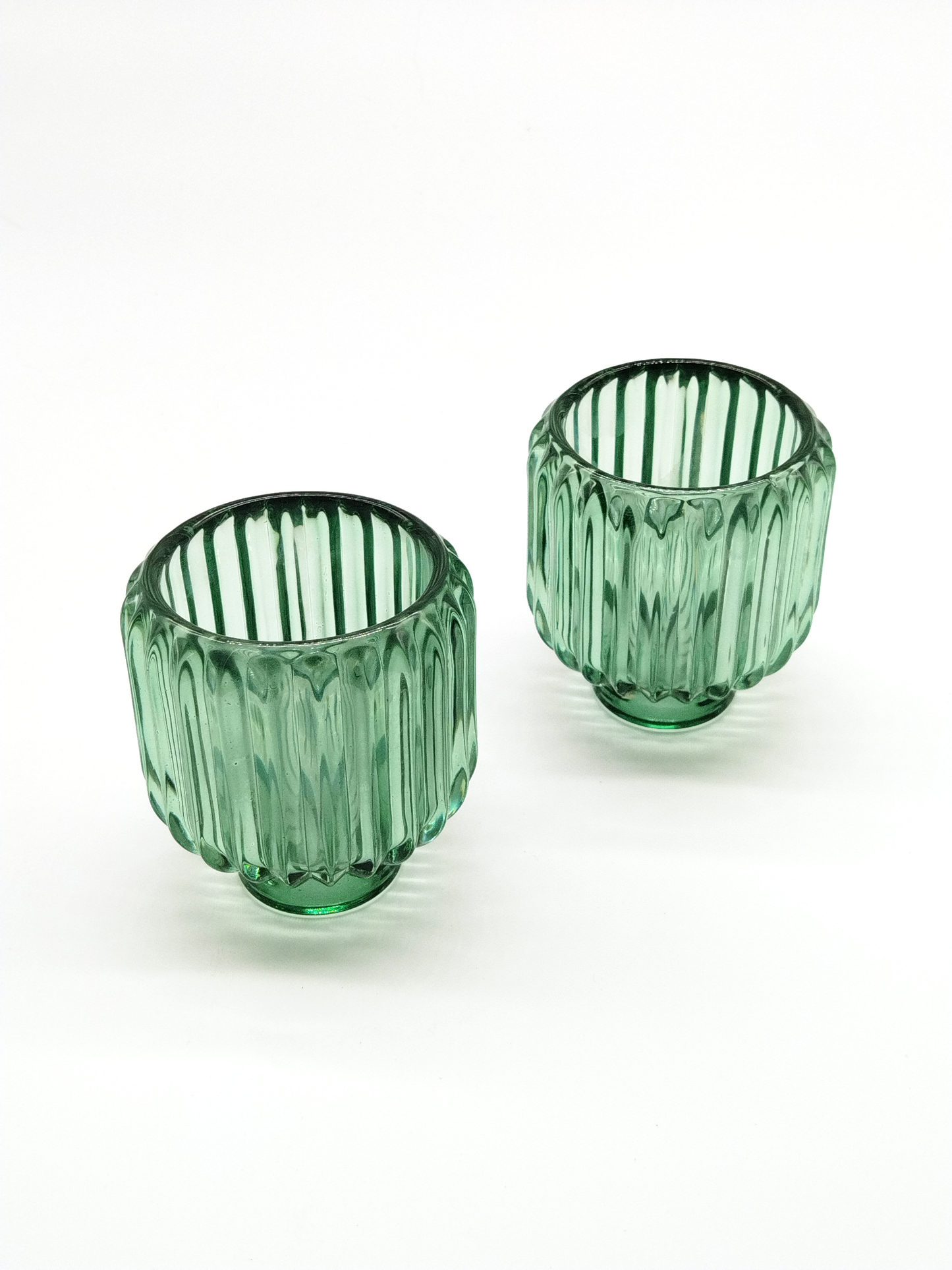 A PAIR OF GREEN GLASS VOTIVE / CANDLE HOLDERS