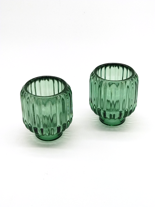 A PAIR OF GREEN GLASS VOTIVE / CANDLE HOLDERS