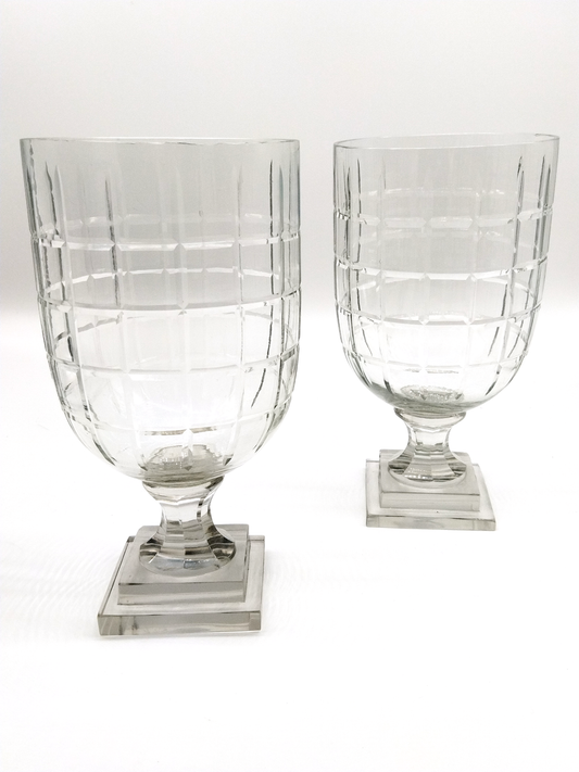 A PAIR OF TALL SQUARE BEVELED CUT GLASS HURRICANE LAMPS WITH SQUARE BASE.